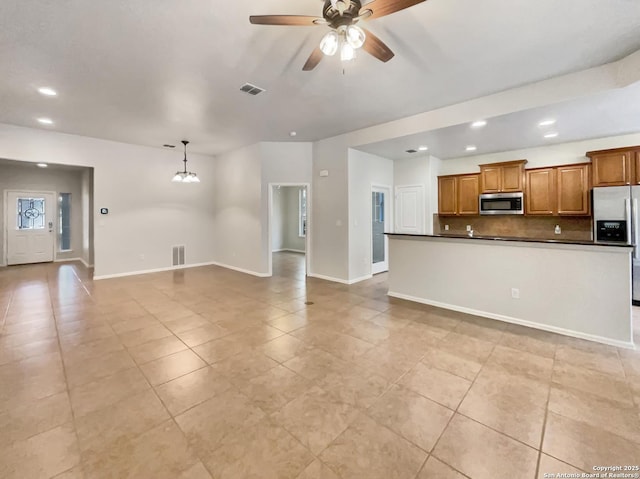 unfurnished living room featuring a ceiling fan, visible vents, light tile patterned floors, and recessed lighting