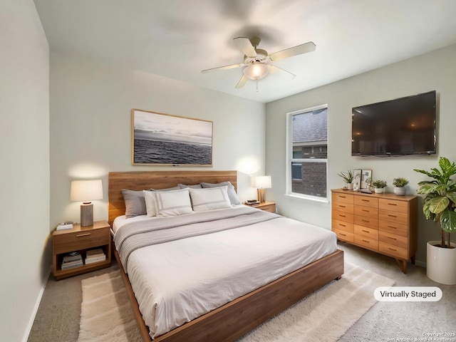 bedroom featuring baseboards, a ceiling fan, and light colored carpet