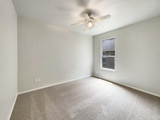 carpeted spare room with baseboards and ceiling fan