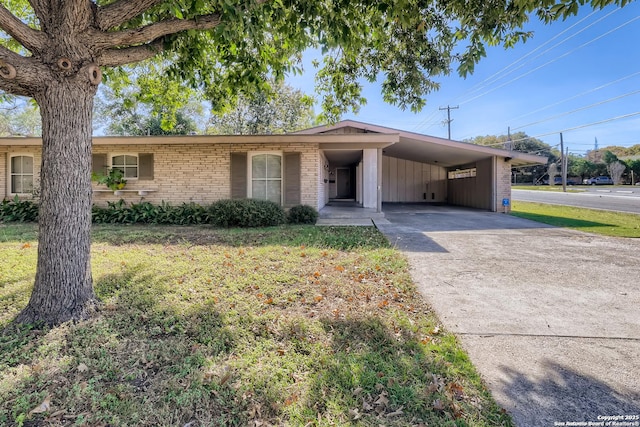 102-106 Oakhurst, San Antonio, TX 78209 - single story home featuring brick siding, an attached carport, concrete driveway, and a front lawn