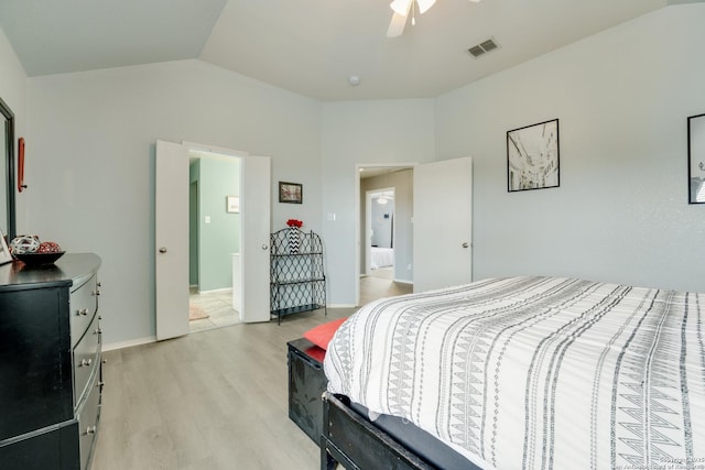 bedroom with visible vents, a ceiling fan, light wood-style flooring, and lofted ceiling
