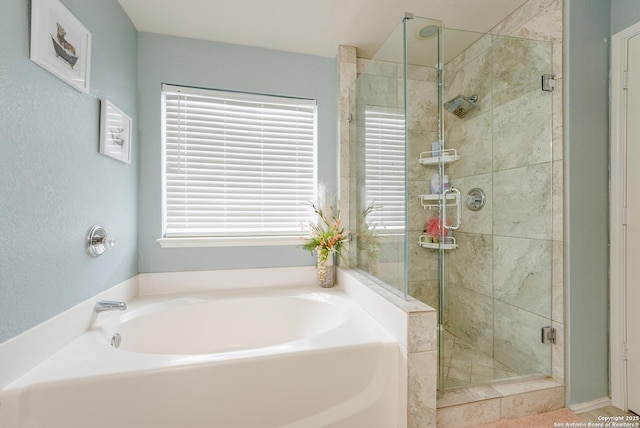 full bath with a shower stall, a garden tub, and plenty of natural light