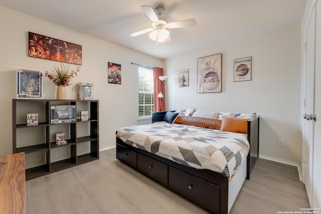 bedroom with baseboards, ceiling fan, and light wood-style floors