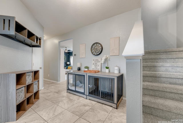 interior space featuring tile patterned flooring and ceiling fan