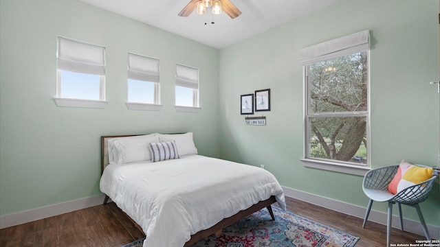 bedroom with baseboards, a ceiling fan, and wood finished floors