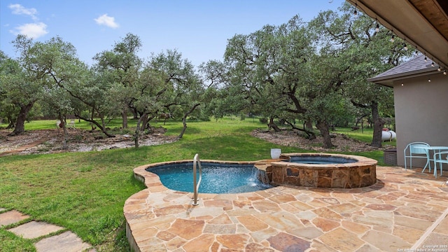 view of swimming pool featuring an in ground hot tub, a yard, and a patio area