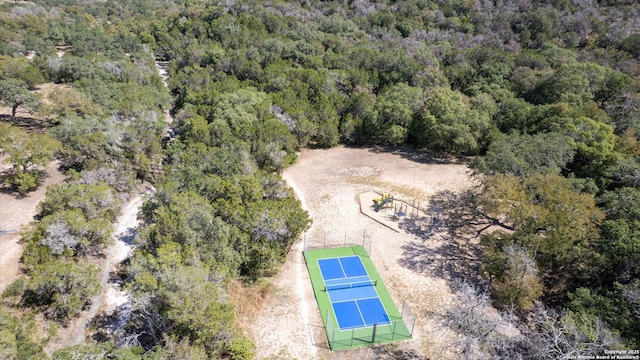 birds eye view of property with a wooded view