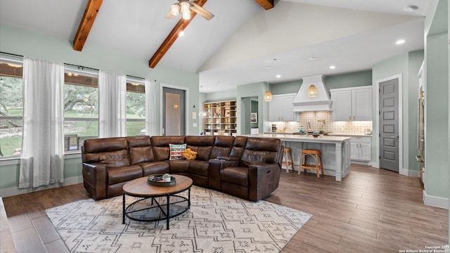 living room with recessed lighting, vaulted ceiling with beams, a ceiling fan, and light wood finished floors
