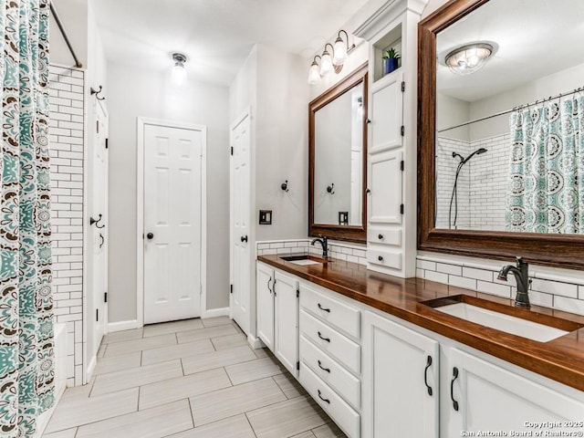 14051 Cedar Cyn, San Antonio, TX 78231 - bathroom featuring double vanity, a sink, and decorative backsplash