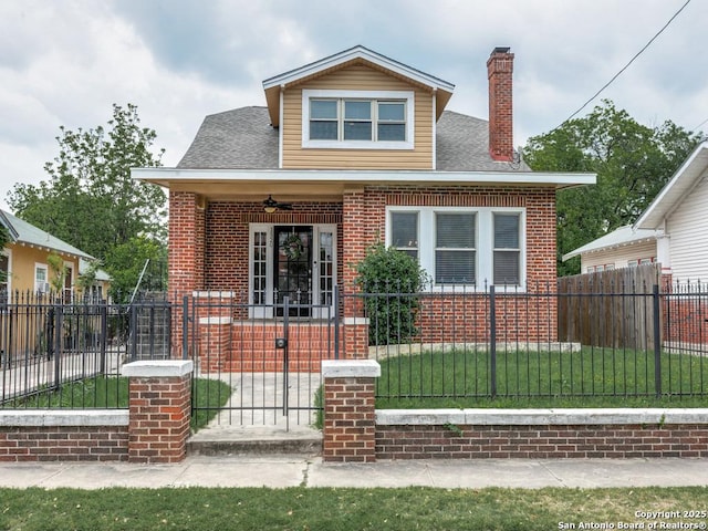 1520 Virginia, San Antonio, TX 78203 - bungalow-style house featuring covered porch, a chimney, brick siding, a gate, and a fenced front yard