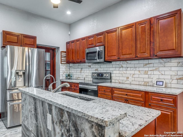 1520 Virginia, San Antonio, TX 78203 - kitchen featuring a sink, decorative backsplash, light stone countertops, and stainless steel appliances