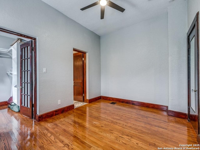 1520 Virginia, San Antonio, TX 78203 - unfurnished bedroom featuring a ceiling fan, baseboards, and wood finished floors