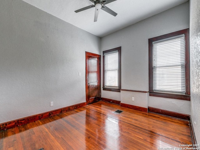 1520 Virginia, San Antonio, TX 78203 - unfurnished room with a ceiling fan, baseboards, visible vents, and wood finished floors