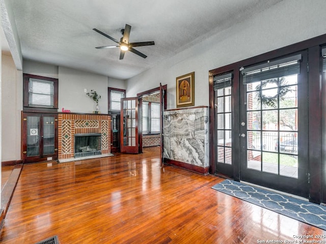 1520 Virginia, San Antonio, TX 78203 - unfurnished living room featuring baseboards, a textured ceiling, ceiling fan, and wood finished floors