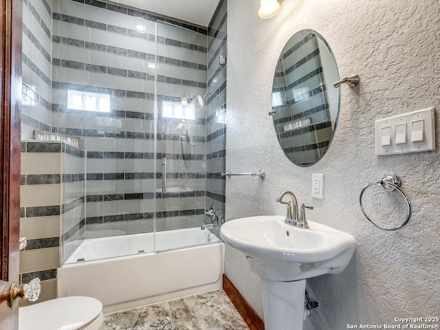 1520 Virginia, San Antonio, TX 78203 - full bathroom featuring a textured wall, bathtub / shower combination, and toilet