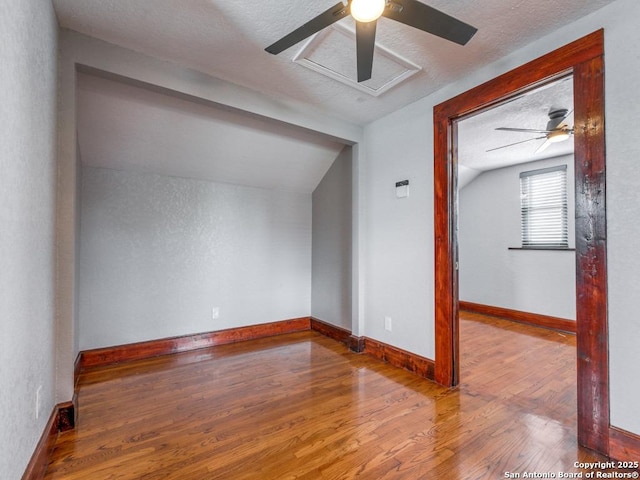 1520 Virginia, San Antonio, TX 78203 - additional living space with a textured ceiling, a ceiling fan, baseboards, wood finished floors, and lofted ceiling