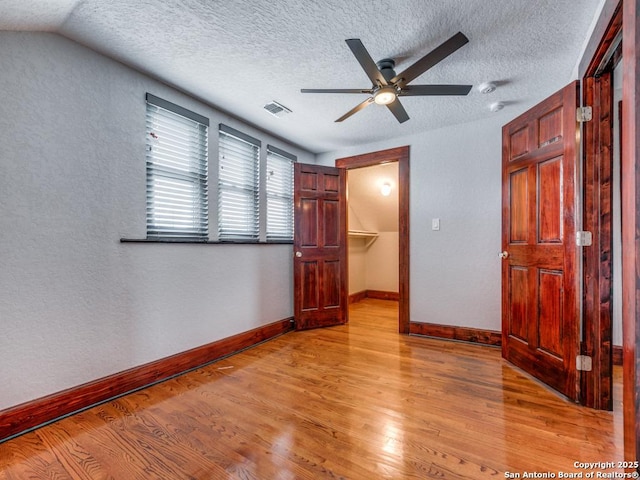 1520 Virginia, San Antonio, TX 78203 - unfurnished bedroom featuring a textured ceiling, baseboards, visible vents, and light wood-type flooring