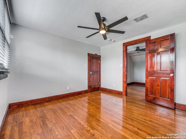 1520 Virginia, San Antonio, TX 78203 - unfurnished bedroom with visible vents, baseboards, ceiling fan, and wood finished floors