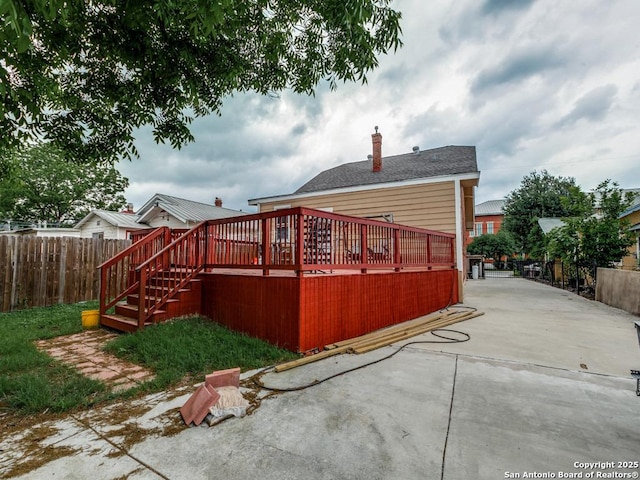 1520 Virginia, San Antonio, TX 78203 - rear view of house featuring a deck, fence, a chimney, and a patio