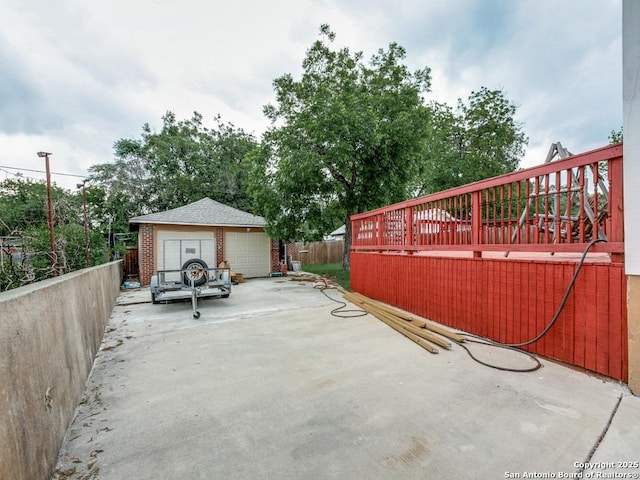 1520 Virginia, San Antonio, TX 78203 - view of patio with fence, an outbuilding, a deck, and a detached garage