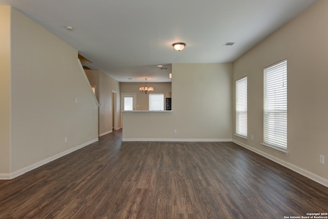 3622 Mill Mdw, San Antonio, TX 78247 - unfurnished living room featuring a chandelier, dark wood-style floors, and baseboards
