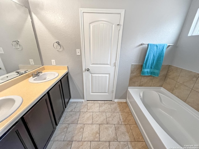 full bath with double vanity, a sink, and a bath