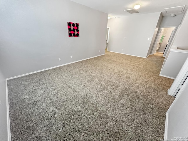 carpeted empty room featuring baseboards and visible vents
