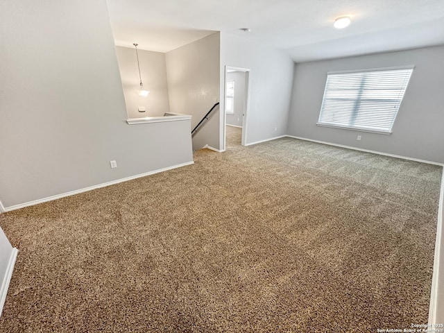 carpeted spare room with baseboards