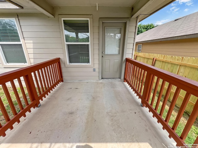 entrance to property featuring fence
