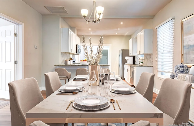 1932 W Huisache, San Antonio, TX 78201 - dining area featuring a chandelier, baseboards, visible vents, and plenty of natural light