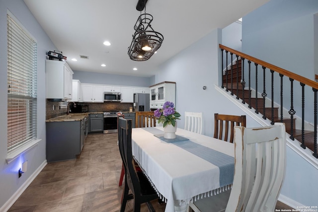 dining room with recessed lighting, baseboards, visible vents, and stairway