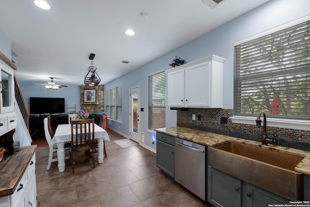kitchen with wooden counters, ceiling fan, tasteful backsplash, a sink, and dishwasher