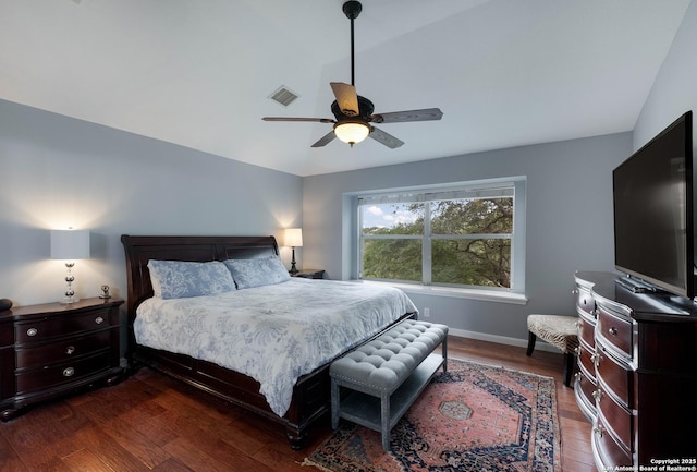 bedroom featuring visible vents, a ceiling fan, dark wood-style flooring, and baseboards
