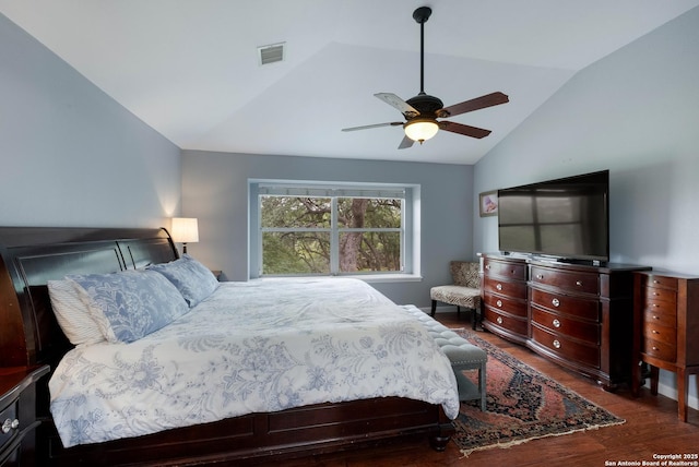 bedroom featuring visible vents, a ceiling fan, wood finished floors, and vaulted ceiling