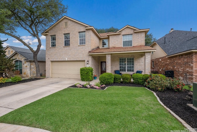 traditional home featuring an attached garage, concrete driveway, a front lawn, and brick siding