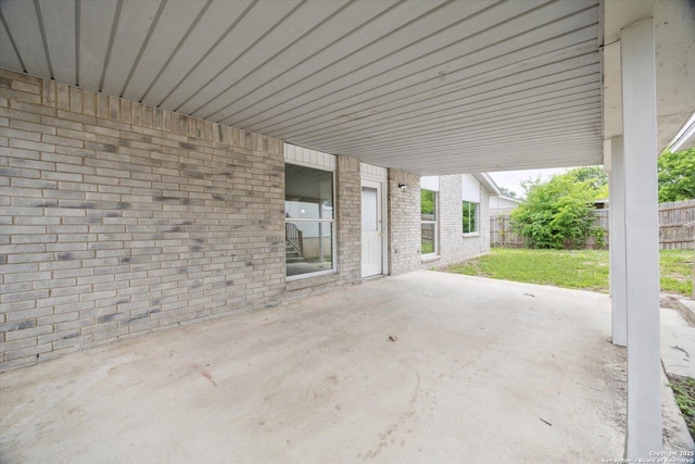 view of patio / terrace with a fenced backyard and a carport