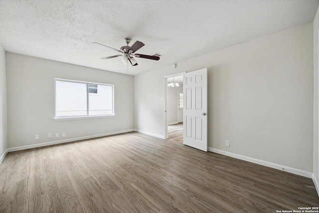 unfurnished room with baseboards, ceiling fan, and wood finished floors