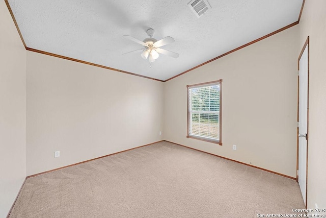 769 Kristen Ln, Harper, TX 78631 - empty room with ceiling fan, light carpet, lofted ceiling, visible vents, and ornamental molding