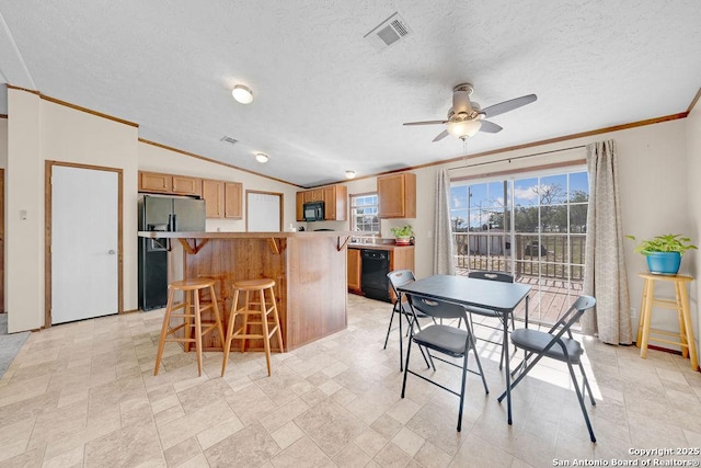 769 Kristen Ln, Harper, TX 78631 - dining room featuring ceiling fan, a textured ceiling, visible vents, crown molding, and lofted ceiling