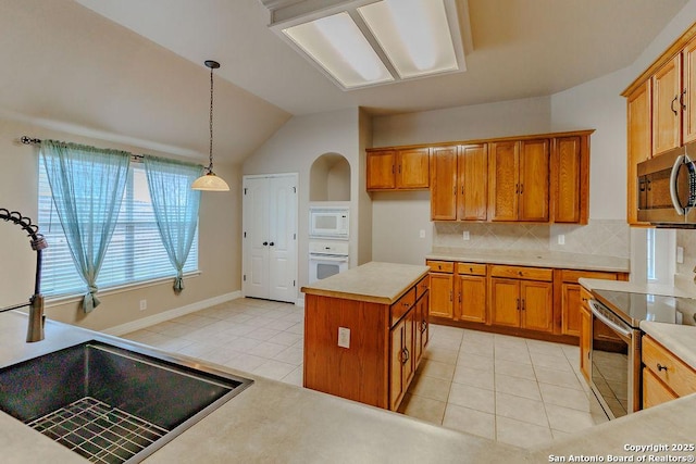 26923 Trinity Hts, San Antonio, TX 78261 - kitchen featuring light tile patterned floors, brown cabinets, a sink, backsplash, and stainless steel appliances