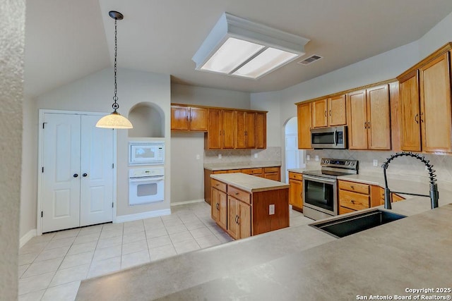 26923 Trinity Hts, San Antonio, TX 78261 - kitchen with visible vents, light countertops, brown cabinets, a sink, and appliances with stainless steel finishes