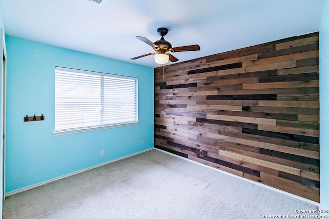 26923 Trinity Hts, San Antonio, TX 78261 - carpeted spare room featuring ceiling fan, wood walls, and baseboards