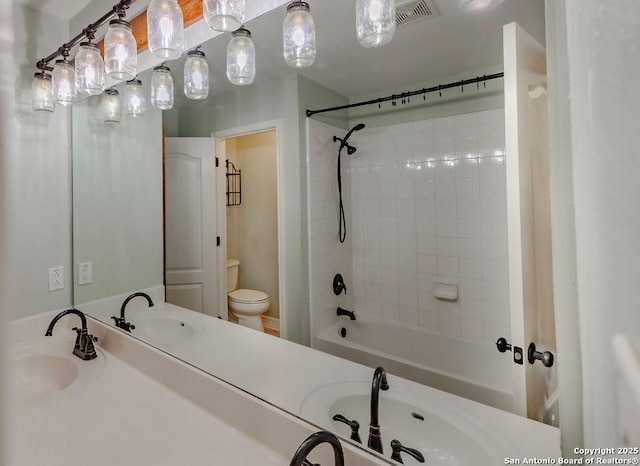 26923 Trinity Hts, San Antonio, TX 78261 - bathroom featuring vanity, shower / bath combo, toilet, and visible vents