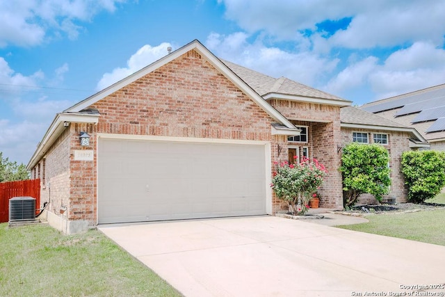26923 Trinity Hts, San Antonio, TX 78261 - view of front of property with brick siding, a garage, central AC, and driveway