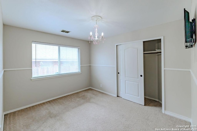 26923 Trinity Hts, San Antonio, TX 78261 - unfurnished bedroom with visible vents, baseboards, a closet, a notable chandelier, and carpet