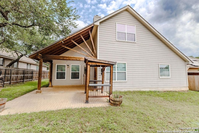 26923 Trinity Hts, San Antonio, TX 78261 - back of house with a lawn, a fenced backyard, a patio area, and a chimney