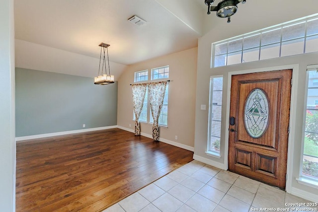 26923 Trinity Hts, San Antonio, TX 78261 - entrance foyer featuring light wood-style floors, a wealth of natural light, a notable chandelier, and visible vents