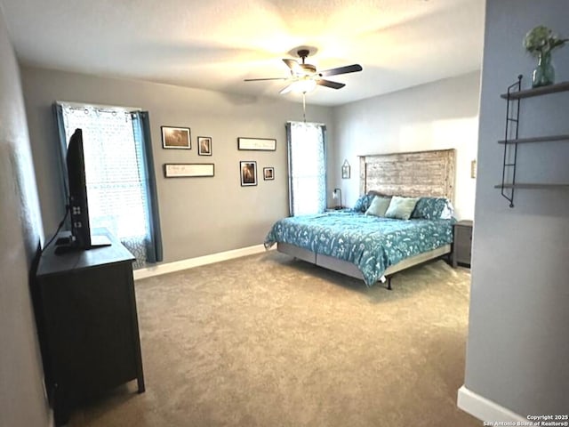 carpeted bedroom with baseboards and ceiling fan