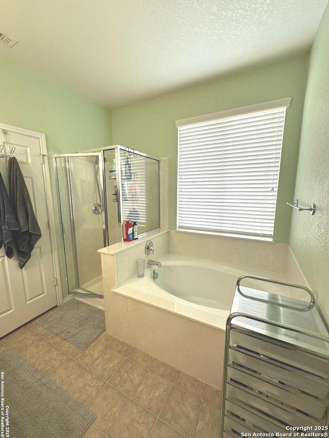 full bath with a garden tub, a textured ceiling, visible vents, a stall shower, and tile patterned floors