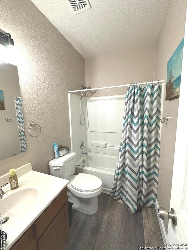 full bath with visible vents, a textured wall, a textured ceiling, and wood finished floors